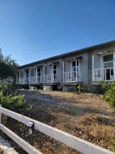 a row of houses with a fence in front at AG Hotel in Dhërmi