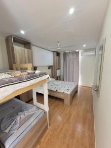 a small room with a bed and a large room with at AG Hotel in Dhërmi