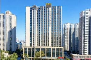a large building in a city with tall buildings at Mercure Lanzhou West in Lanzhou