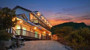 a house with lights on the side of it at Hwacheon Turkey Valley in Hwach'ŏn