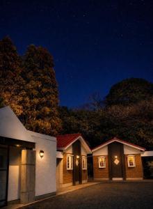 a row of houses at night with lights at ホテルwith宮崎 in Miyazaki