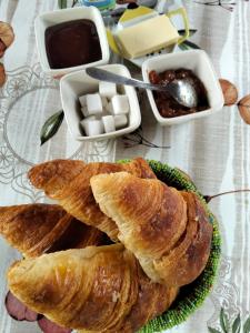 a plate of croissants on a table with other foods at Karibu Normandy-Maasai in Lisieux