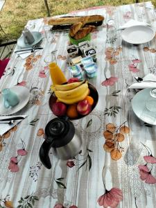 a table with a bowl of fruit on it at Karibu Normandy-Maasai in Lisieux +3 photos