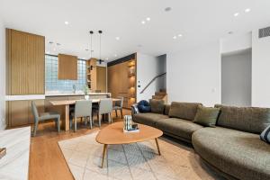 a living room with a couch and a table at Brighton Beach Terrace in Melbourne