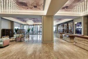 a lobby of a building with a library with furniture at Mercure Lanzhou West in Lanzhou
