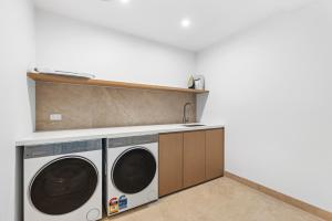 a laundry room with a washer and dryer at Brighton Beach Terrace in Melbourne