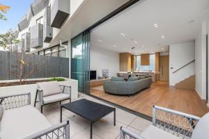 an open living room with a couch and chairs at Brighton Beach Terrace in Melbourne