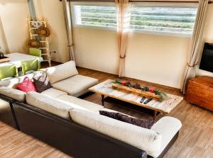 a living room with a couch and a table at EuZoea Country Home 1 Nature Escape with Pool in Kapandrítion