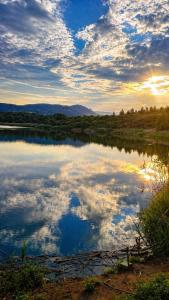 a reflection of the sky in a body of water at EuZoea Country Home 1 Nature Escape with Pool in Kapandrítion