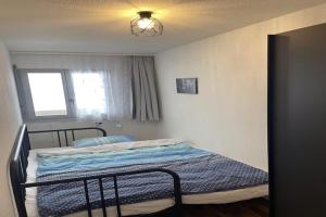 a bedroom with a bed in a room with a window at Charming apartment with hill view in Veysonnaz +30 photos