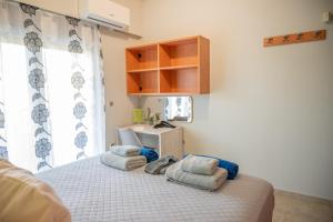 a bedroom with a bed with towels on it at Erato Superior Suite in Kremasti +35 photos