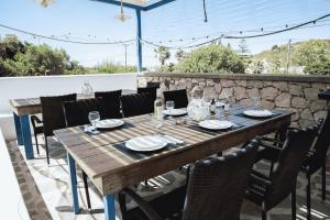 a wooden table and chairs on a patio at Erato Superior Suite in Kremasti