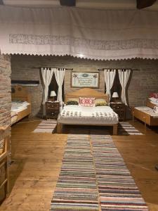 a bedroom with a bed and two tables and a rug at La Hansi in Crit in Criţ