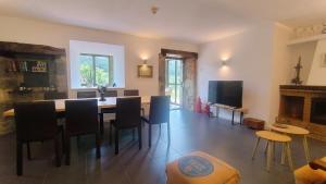 a dining room with a table and chairs and a fireplace at Hotel Boutique Villa de Palacios - Palacio de Aras in San Miguel de Aras