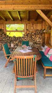 a wooden table and chairs on a patio at Chalet Milanovic in Dalaas