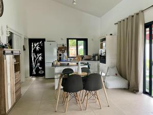 a kitchen with a table and chairs in a room at La Kazbanon in La Possession