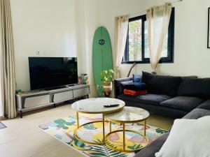 a living room with a couch and a tv at La Kazbanon in La Possession +5 photos