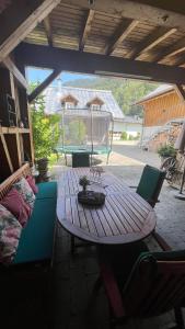 a wooden table and chairs on a patio at Chalet Milanovic in Dalaas