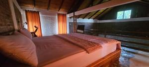 a bedroom with a large bed in a room at Lentera Lombok in Tetebatu