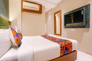 a bedroom with a bed and a flat screen tv at FabHotel Ruby Grand in Mumbai +31 photos