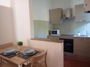 a kitchen with a table with plates on it at Nidus in Aulla +6 photos
