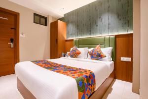 a bedroom with a large bed in a room at FabHotel Ruby Grand in Mumbai