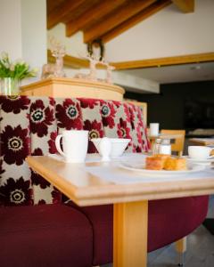 a wooden table with a plate of food on it at Mountain Paradise in Zermatt