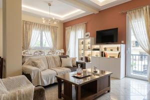 a living room with a couch and a table at mastic flavored sweet in Chios