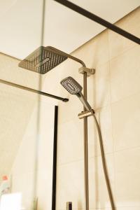 a shower in a bathroom with a shower head at Давидів Хутір in Zhytomyr +21 photos