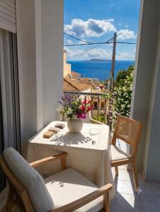 a table with a vase of flowers on a balcony at mastic flavored sweet in Chios