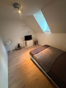 a bedroom with a bed and a desk and a window at La chambre de Gray in Gray