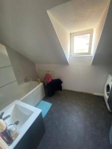 a small bathroom with a sink and a window at La chambre de Gray in Gray