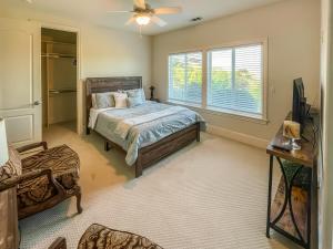 a bedroom with a bed and a window at Serrano Village Villa in El Dorado Hills +39 photos