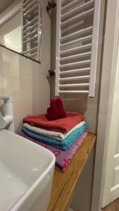 a bathroom with a stack of towels on a counter at Apartment Tarasy centrum in Siemiatycze +21 photos