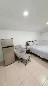 a bedroom with two beds and a bed and a chair at HollywoodCozyStudio in Hollywood