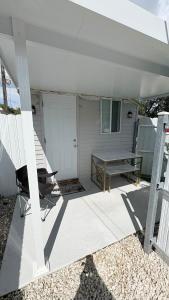 a porch with a picnic table and a bench at HollywoodCozyStudio in Hollywood