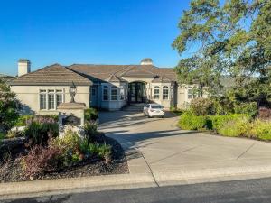 a house with a car parked in the driveway at Serrano Village Villa in El Dorado Hills