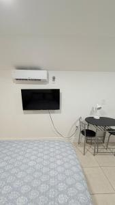 a living room with a table and a white wall at HollywoodCozyStudio in Hollywood