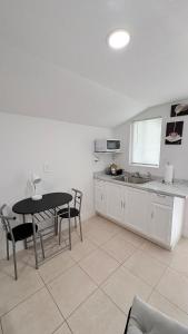 a kitchen with a table and chairs and a table and a counter at HollywoodCozyStudio in Hollywood