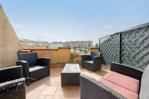 a patio with chairs and tables on a balcony at Daluef Alloggi in Assemini