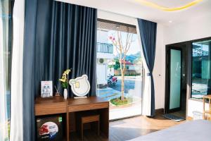 a bedroom with a bed and a large window at Home Mộc Mer Mộc Châu in Mộc Châu +58 photos