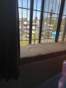 a window in a room with a view of a beach at Grantley -Beach hotel Alibag in Alībāg