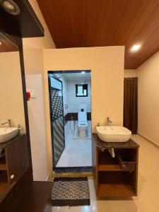 a bathroom with two sinks and a toilet at WKND Casa in Panchgani +20 photos
