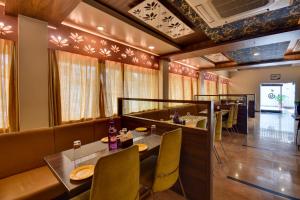 a dining room with a table and chairs at Hotel Bhagyalaxmi in Shirdi