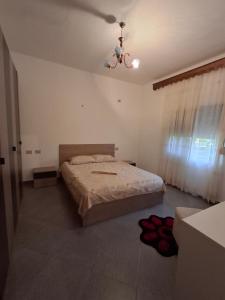 a bedroom with a bed and a ceiling at Hills Villa in Vlorë