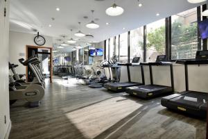 a gym with treadmills and elliptical machines at DAVINCI Suites in Johannesburg