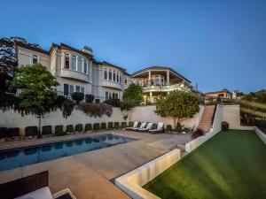 a mansion with a swimming pool and a house at Serrano Village Villa in El Dorado Hills