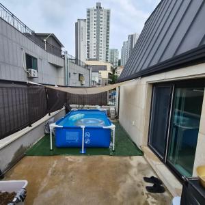 a hot tub on the roof of a building at YYStay 감성 루프탑 in Seoul