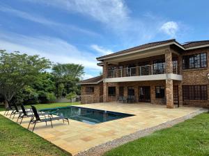 a house with a swimming pool in the yard at Avocado Grove Guest House in White River