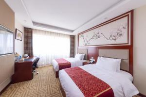 a hotel room with two beds and a desk at Golden Inns Beijing South Railway金泰之家北京南站店 in Beijing +45 photos